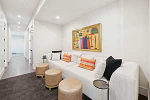 Living area with recessed lighting and baseboards