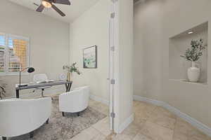 Office space featuring ceiling fan and light tile patterned floors