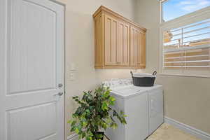 Laundry room with cabinet space and washer and dryer