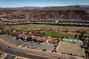 Aerial view of property and surrounding area with a mountain backdrop and nearby suburban area