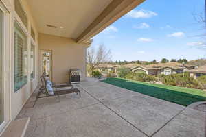 View of patio with a residential view and area for grilling