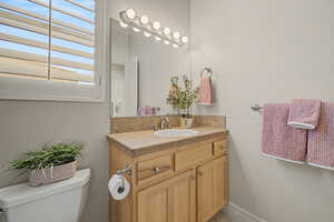 Bathroom featuring vanity and toilet