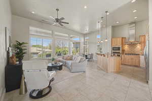Living room featuring a ceiling fan and recessed lighting