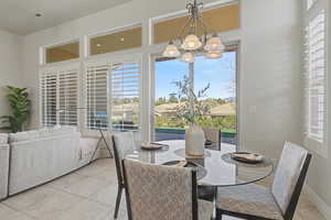 Dining space featuring light tile patterned flooring and healthy amount of natural light