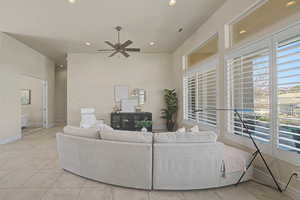 Living room featuring recessed lighting, ceiling fan, light tile patterned flooring, and healthy amount of natural light