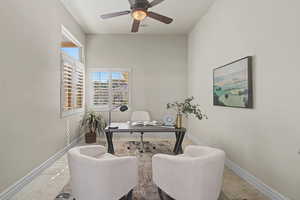 Office with baseboards and ceiling fan