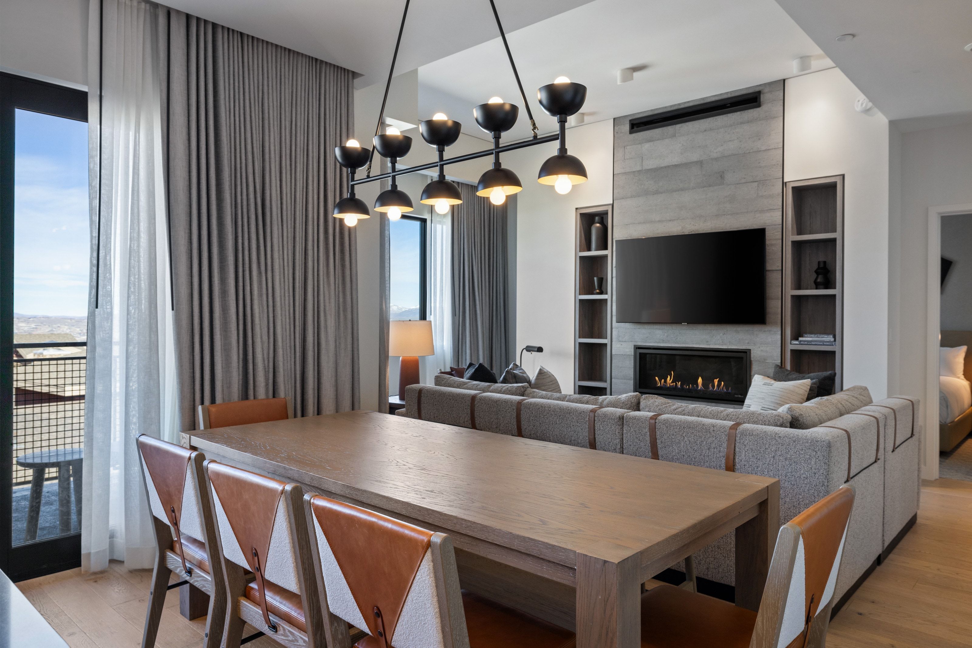 Dining area featuring light wood-style flooring and a fireplace