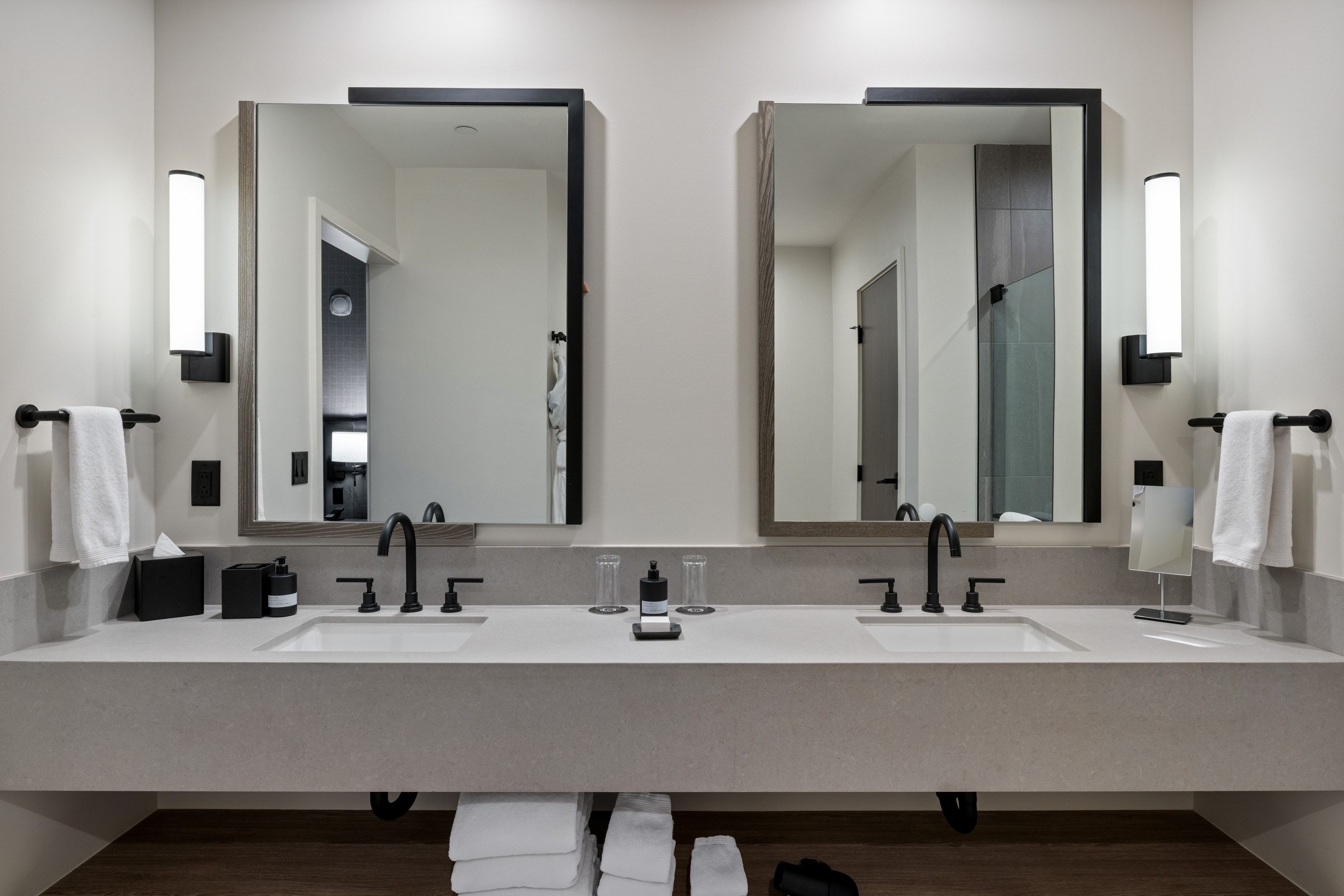 Bathroom featuring double vanity and a stall shower