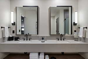 Bathroom featuring double vanity and a stall shower