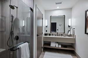Bathroom featuring a stall shower and vanity