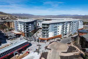 Drone / aerial view of apartment complex / building and a mountain backdrop