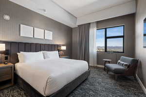 Bedroom featuring dark carpet and wallpapered walls