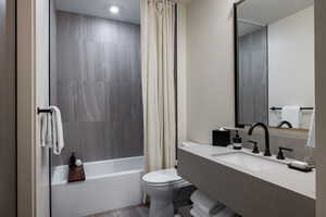 Full bathroom featuring vanity and shower / bath combo with shower curtain