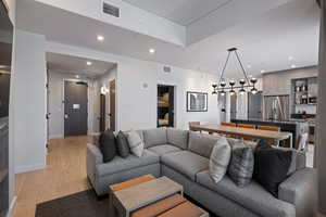 Living room with recessed lighting and light wood-style floors