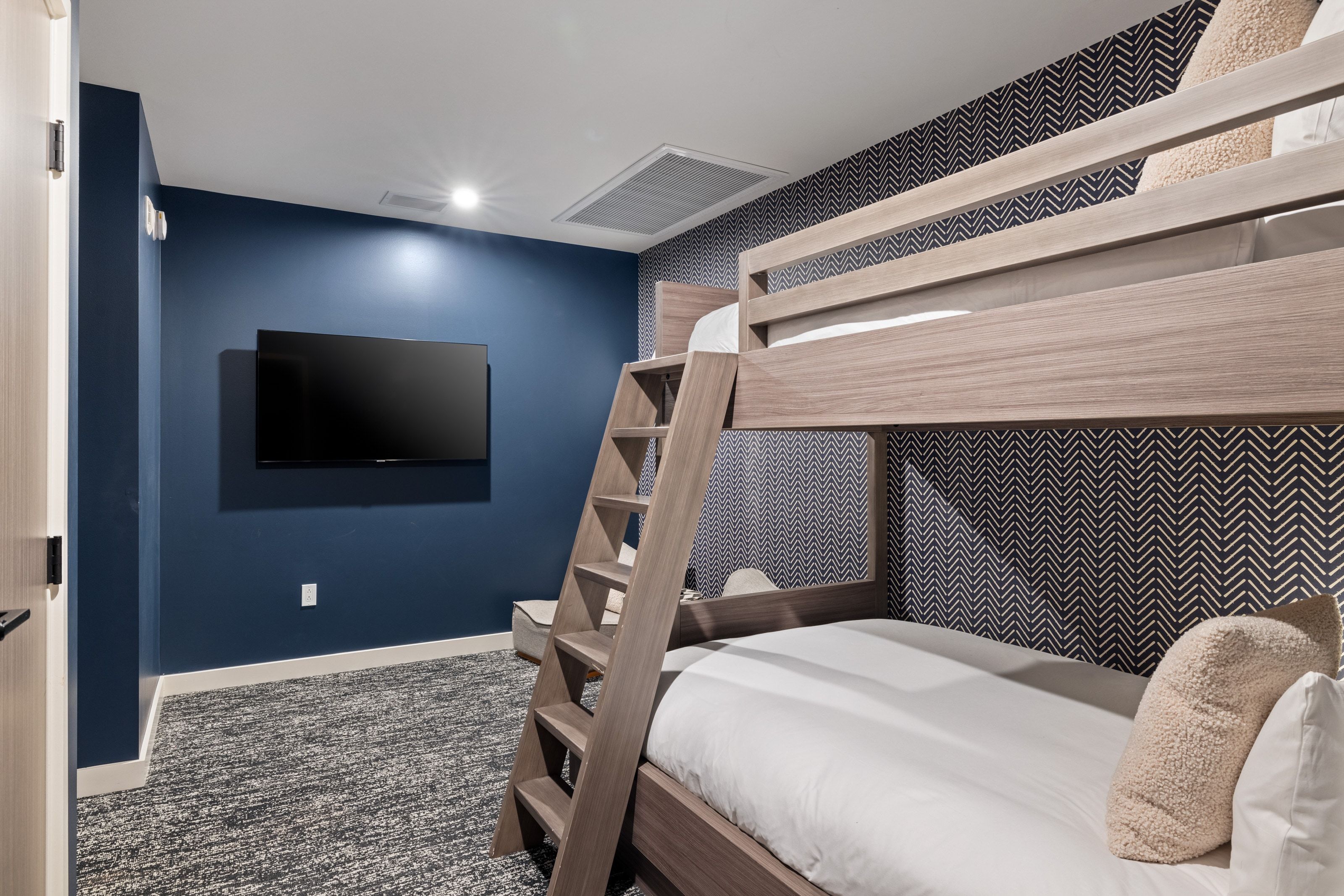 Bedroom with dark colored carpet and baseboards