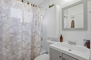Bathroom featuring vanity and shower / bath combo with shower curtain