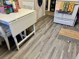 Unit 4367 Detailed view of white range with electric stovetop and laminate floors