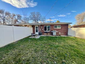 4365 Rear view of house with a secluded fenced backyard, brick siding, and a patio