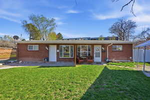 Rear view of property featuring brick siding