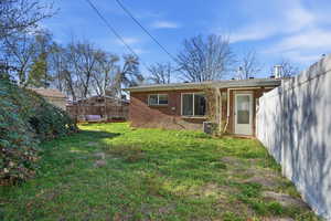 Rear view of house with brick siding