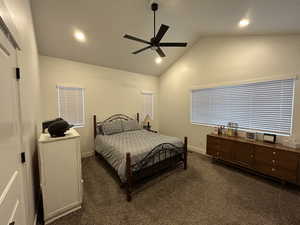 Bedroom featuring ceiling fan, vaulted ceiling, dark colored carpet, and recessed lighting