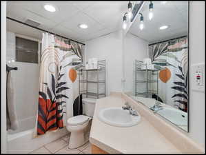 Bathroom with recessed lighting, vanity, light tile patterned flooring, and shower / tub combo
