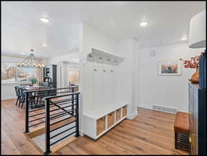 Mud area with light wood-style LVP floors, recessed lights, and a textured ceiling