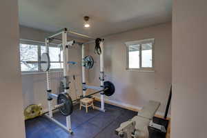 Workout area featuring dark rubber floors and baseboards