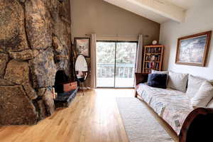 Living area featuring light wood-style floors and vaulted ceiling