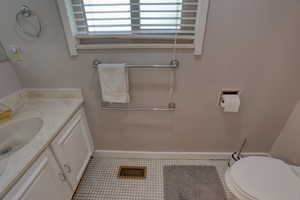Half bath with vanity and light tile patterned floors