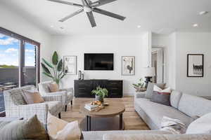 Living area with light wood-style floors, a ceiling fan, and recessed lighting