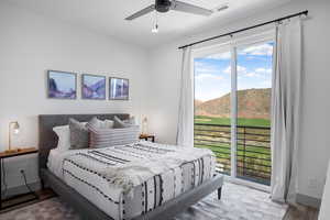 Bedroom with access to exterior, wood finished floors, a mountain view, a ceiling fan, and recessed lighting