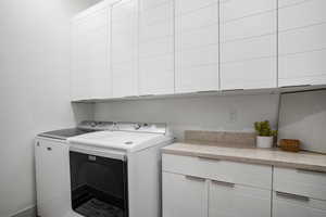 Laundry room with washing machine and dryer and cabinet space