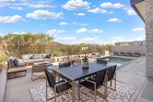 View of patio / terrace with a mountain view and an outdoor living space with a fire pit