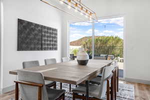 Dining room with light wood-type flooring and baseboards