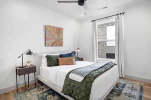Bedroom featuring wood finished floors, a ceiling fan, and recessed lighting