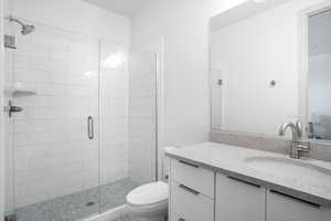 Bathroom featuring vanity and a stall shower