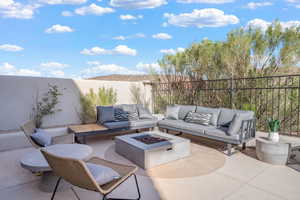 Fenced backyard with a patio area and an outdoor living space with a fire pit