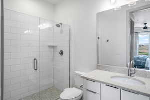 Bathroom with ensuite bath, vanity, a stall shower, and a ceiling fan