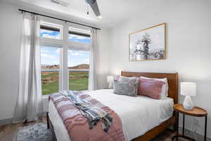 Bedroom featuring wood finished floors, a mountain view, ceiling fan, and recessed lighting