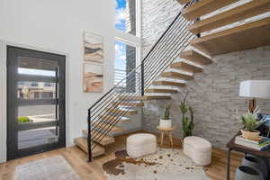 Entryway featuring a high ceiling, light wood-style floors, and healthy amount of natural light