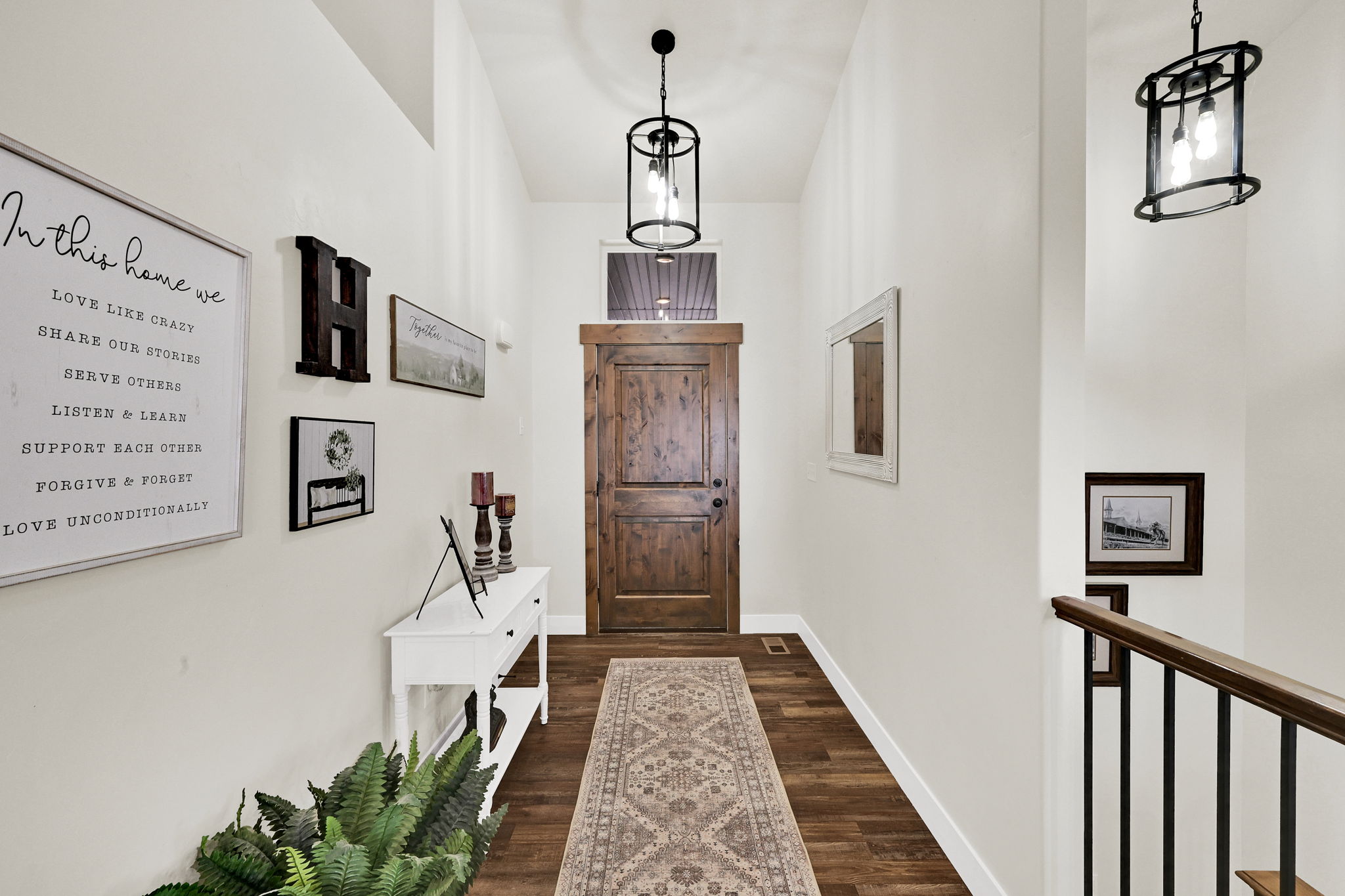 Doorway with wood finished floors and baseboards
