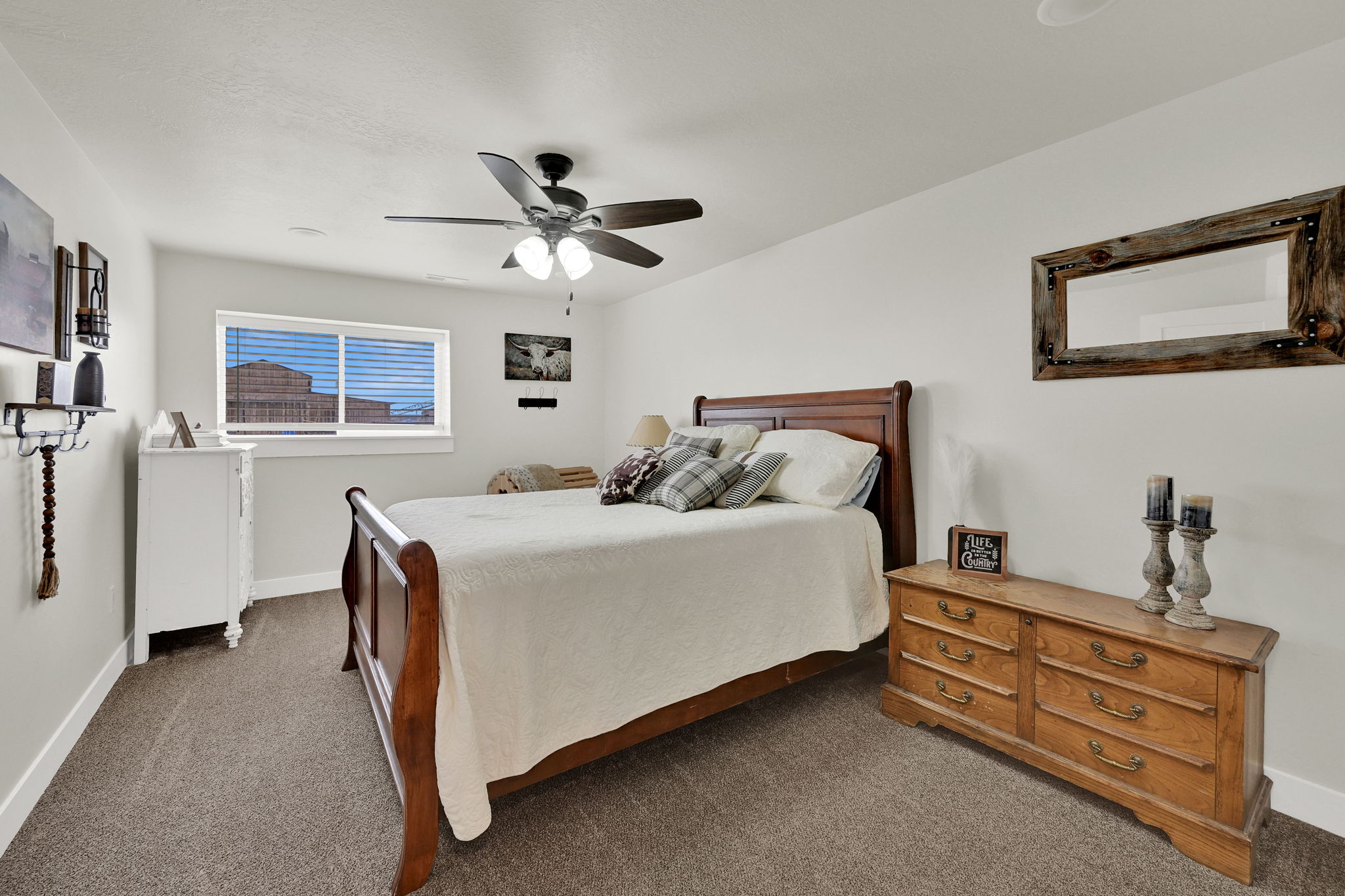 Bedroom featuring dark carpet and ceiling fan