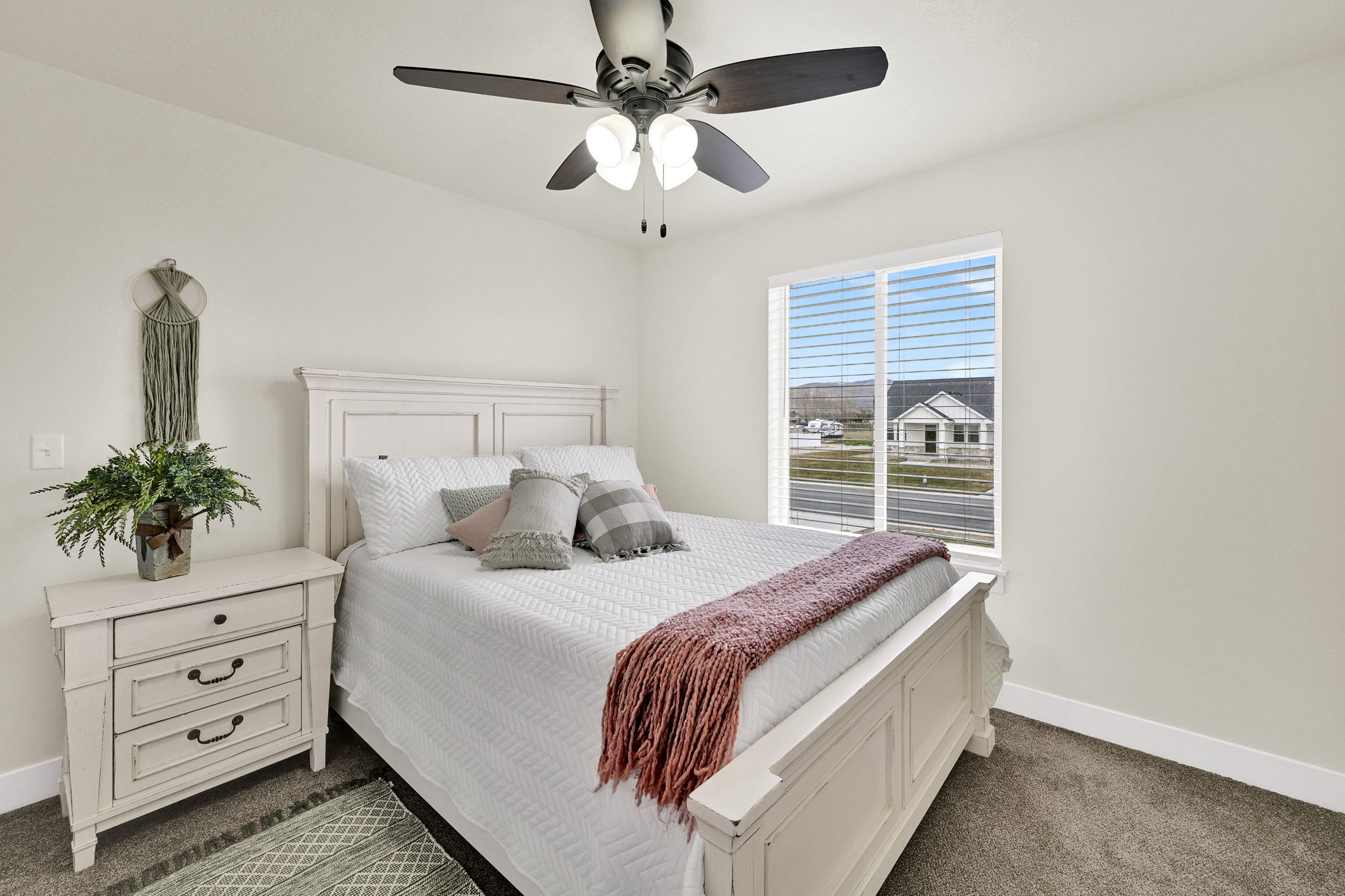 Bedroom featuring dark colored carpet and a ceiling fan