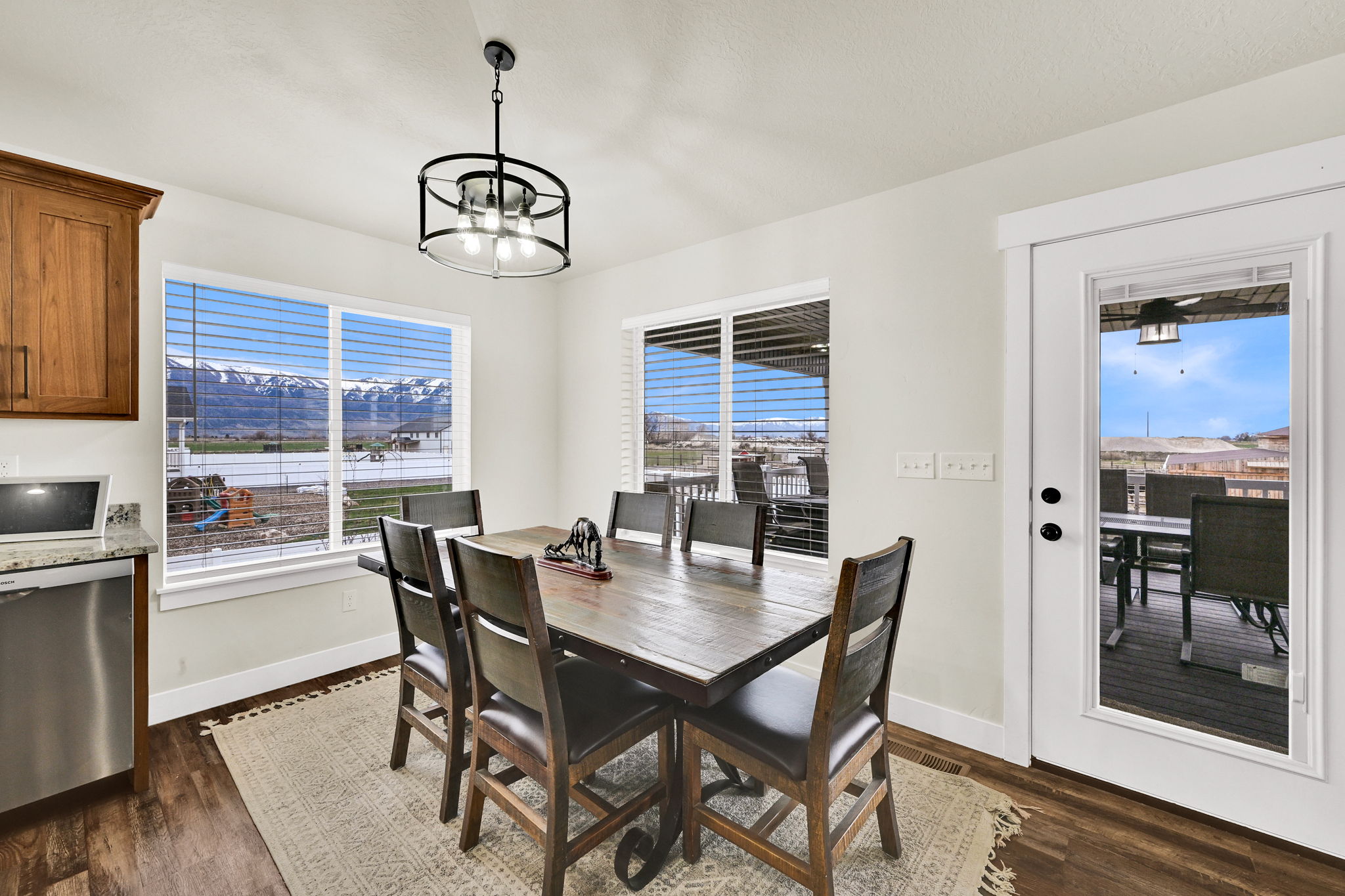 Dining space featuring dark wood finished floors, a chandelier, and a mountain view