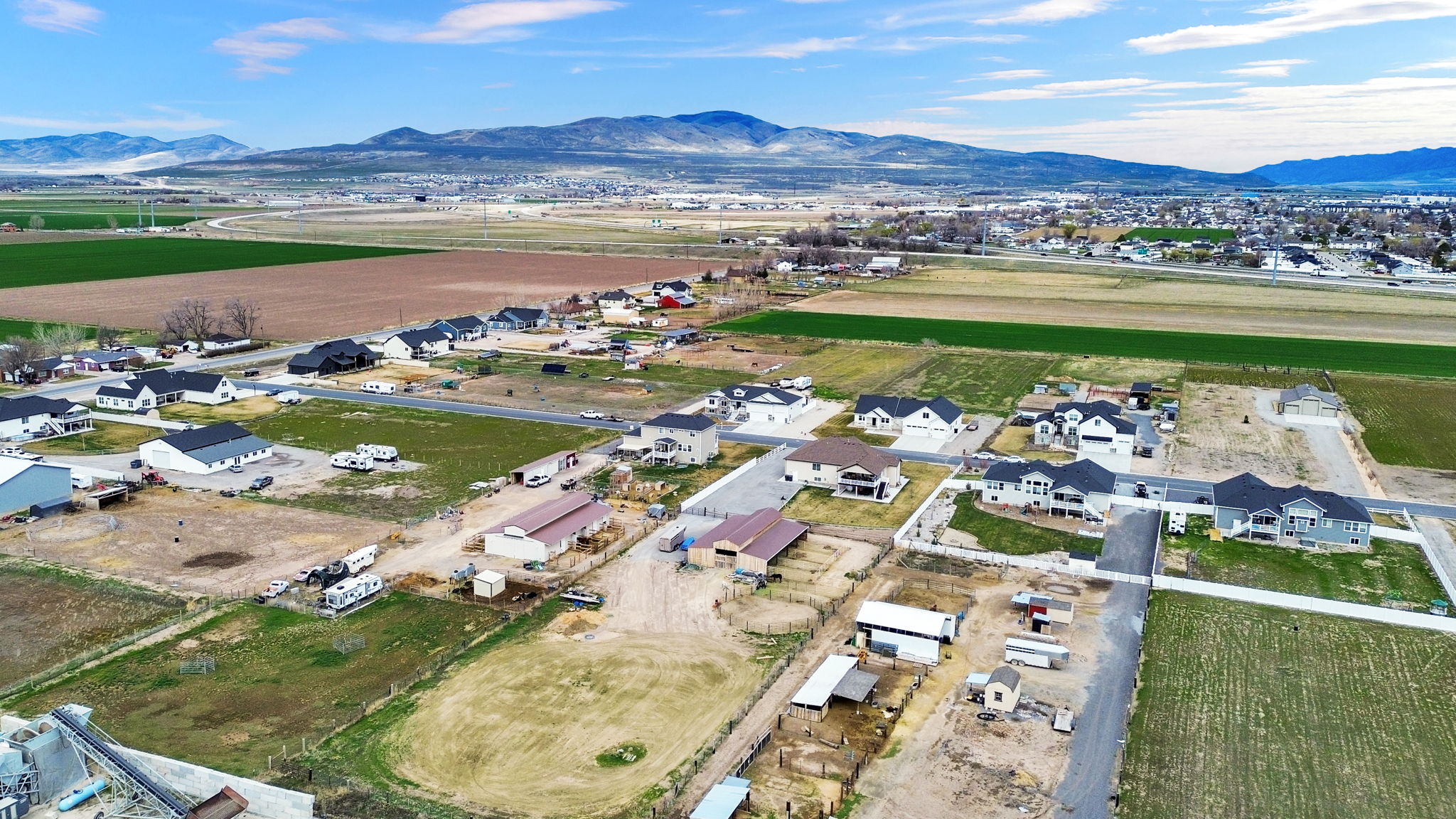 Aerial overview of property's location featuring nearby suburban area and a mountain backdrop