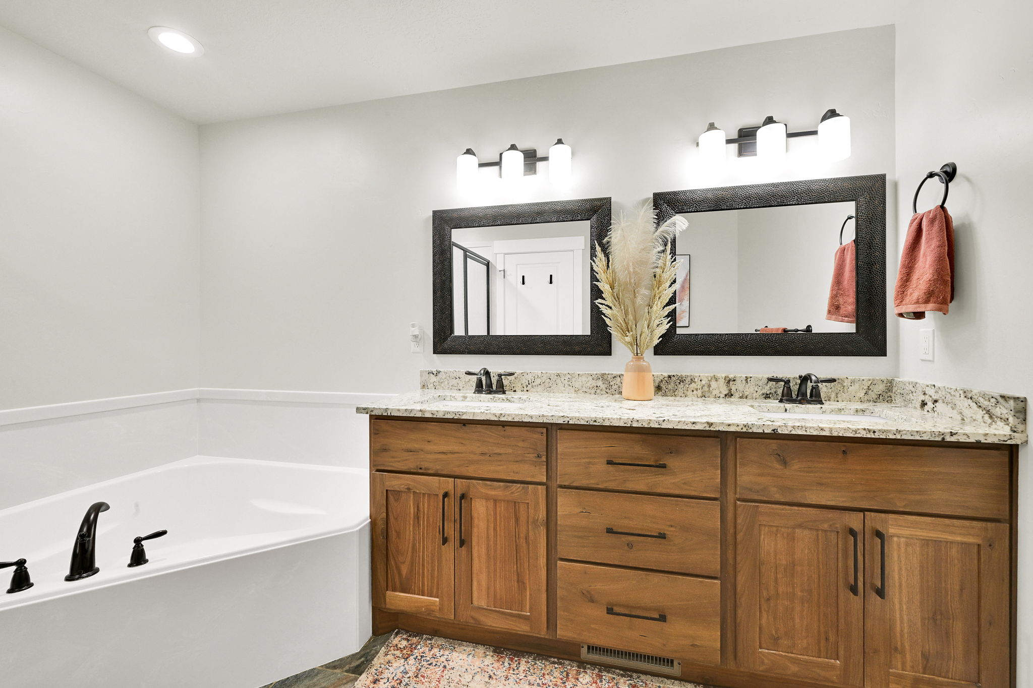 Bathroom with double vanity, a garden tub, and recessed lighting