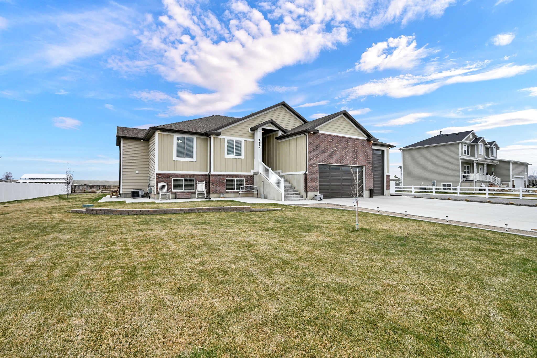 View of front of house with brick siding, concrete driveway, and an attached garage