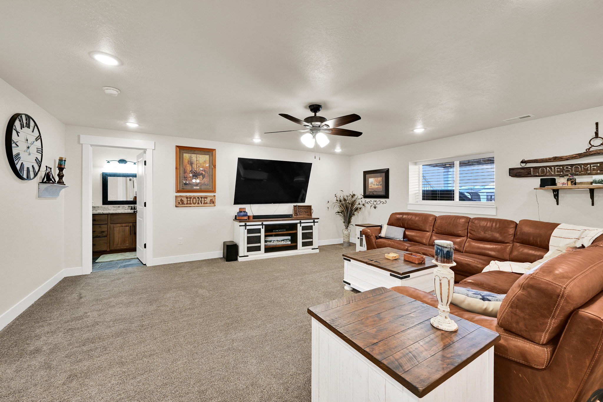 Living room featuring light colored carpet, a ceiling fan, and recessed lighting