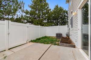 Fenced backyard with a patio and a gate